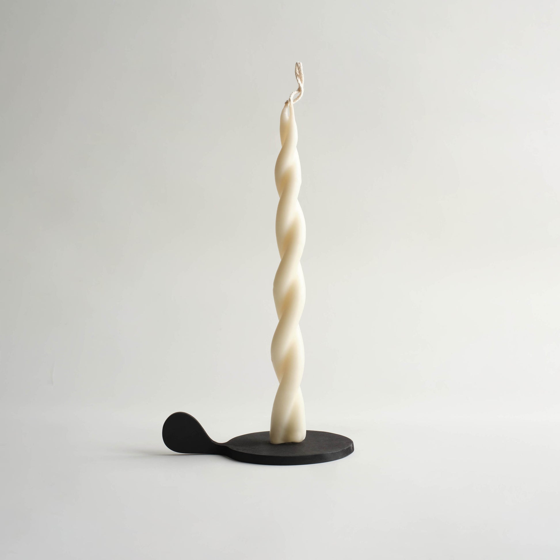 black candle holder with twisted off white candle